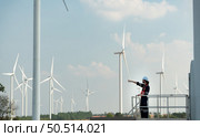 Engineer at Natural Energy Wind Turbine site with a mission to climb up to the wind turbine blades to inspect the operation of large wind turbines that converts wind energy into electrical energy. Стоковое фото, агентство Ingram Publishing / Фотобанк Лори