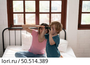 Little boy using small binoculars. A new toy my mom bought me to play with. Стоковое фото, агентство Ingram Publishing / Фотобанк Лори