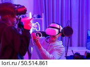 Two professional gamer playing games through VR machine that responds to very fun exciting and provocative. Стоковое фото, агентство Ingram Publishing / Фотобанк Лори