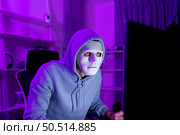 This is the face of a hacker who is knowledgeable with operating systems and other programs. He will exploit flaws and breach the computer system to cause damage. Стоковое фото, агентство Ingram Publishing / Фотобанк Лори