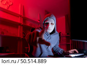 This is the face of a hacker who is knowledgeable with operating systems and other programs. He will exploit flaws and breach the computer system to cause damage. Стоковое фото, агентство Ingram Publishing / Фотобанк Лори