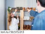 A young couple runs a small business making clay jewelry. They support one another as they work toward becoming larger business in the future. Стоковое фото, агентство Ingram Publishing / Фотобанк Лори