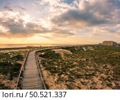 View from the walkway south of Furadouro beach in Ovar on a stormy day at sunset. Стоковое фото, агентство Ingram Publishing / Фотобанк Лори