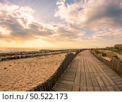 View from the walkway south of Furadouro beach in Ovar on a stormy day at sunset. Стоковое фото, агентство Ingram Publishing / Фотобанк Лори