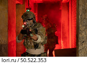 Soldier in anti-terrorist warfare in a dark building, Anti-terrorist operation training on the battlefield. Стоковое фото, агентство Ingram Publishing / Фотобанк Лори