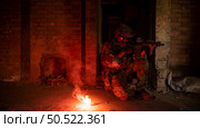 Soldier in anti-terrorist warfare in a dark building, Anti-terrorist operation training on the battlefield. Стоковое фото, агентство Ingram Publishing / Фотобанк Лори