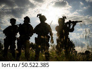 Soldier holding gun and showing action success or war win, special forces military training concept. Стоковое фото, агентство Ingram Publishing / Фотобанк Лори