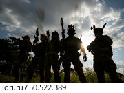 Soldier holding gun and showing action success or war win, special forces military training concept. Стоковое фото, агентство Ingram Publishing / Фотобанк Лори
