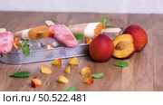 Homemade raspberries and peach popsicles on a wooden table. Стоковое фото, агентство Ingram Publishing / Фотобанк Лори
