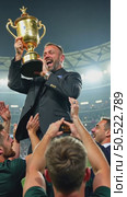A heartwarming moment of a rugby team lifting their coach in celebration, their faces filled with joy, the trophy gleaming in the arms. first prize championship. Стоковое AI-видео, аниматор Sergey Grishin / Фотобанк Лори