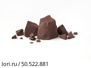 Natural dark chocolate pieces on white background with space for text. Perfect sweet snack.. Natural dark chocolate pieces on white background. Стоковое фото, агентство Ingram Publishing / Фотобанк Лори