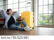 Asian young man traveler prepare to travel again. Стоковое фото, агентство Ingram Publishing / Фотобанк Лори
