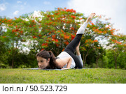 Young female with outdoor activities in the city park, Yoga is her chosen activity. Стоковое фото, агентство Ingram Publishing / Фотобанк Лори