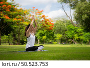 Young female with outdoor activities in the city park, Yoga is her chosen activity. Стоковое фото, агентство Ingram Publishing / Фотобанк Лори