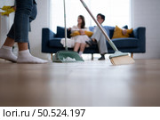 Home owner couple supervise the cleaning of the housekeeper. Стоковое фото, агентство Ingram Publishing / Фотобанк Лори