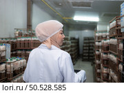 Portrait of a female scientist carrying a box with mushroom lumps in a sterile and temperature-controlled room. Стоковое фото, агентство Ingram Publishing / Фотобанк Лори