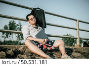Young Asian Businessman with laptop wearing shirt and tie with shorts and eyeglasses with problems and stress or disappointment of work at outside corporate office, copy space. Стоковое фото, агентство Ingram Publishing / Фотобанк Лори