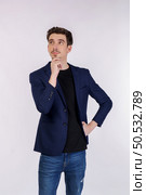 Portrait of young businessman thinking touching chin isolated over white background. Thinking worried about a question, concerned and nervous with hand on chin. Стоковое фото, агентство Ingram Publishing / Фотобанк Лори