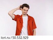 Portrait of thinking man surrounded by question mark on isolated background. Finding inspiration or solution to problem. Стоковое фото, агентство Ingram Publishing / Фотобанк Лори