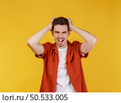 Portrait of thinking man surrounded by question mark on isolated background. Finding inspiration or solution to problem. Стоковое фото, агентство Ingram Publishing / Фотобанк Лори