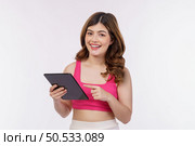 Portrait of excited young woman holding tablet isolated over white background. Technology, people and lifestyle concept. Стоковое фото, агентство Ingram Publishing / Фотобанк Лори