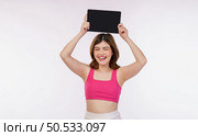 Portrait of excited young woman holding tablet mock up isolated over white background. Technology, people and lifestyle concept. Стоковое фото, агентство Ingram Publishing / Фотобанк Лори