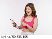 Portrait of excited young woman holding tablet isolated over white background. Technology, people and lifestyle concept. Стоковое фото, агентство Ingram Publishing / Фотобанк Лори