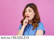 Portrait of excited young woman wearing casual t-shirt surprising isolated over pink background. Expression, people and lifestyle concept. Стоковое фото, агентство Ingram Publishing / Фотобанк Лори