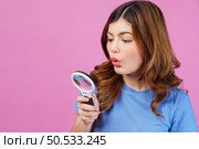 Portrait of excited young woman wearing casual t-shirt surprising isolated over pink background. Expression, people and lifestyle concept. Стоковое фото, агентство Ingram Publishing / Фотобанк Лори