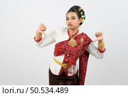 Portrait young pretty woman dress up in beautiful  local culture in northern region with gladtful posture, grimace and thumb down on white background, copy space. Стоковое фото, агентство Ingram Publishing / Фотобанк Лори