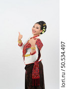 Portrait young pretty woman dress up in beautiful  local culture in northern region with gladtful posture, grimace and thumb up and smile on white background, copy space. Стоковое фото, агентство Ingram Publishing / Фотобанк Лори