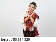 Portrait Young beautiful woman in northeastern dress, she raising hand in Thai dance with charming smile on white background, copy space . Стоковое фото, агентство Ingram Publishing / Фотобанк Лори