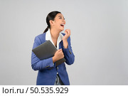 Portrait Asian young woman in officer uniform feel exciting during holding laptop computer in hand posture,  Pretty girl smiling with happy, isolated on white background. Стоковое фото, агентство Ingram Publishing / Фотобанк Лори