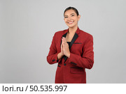 Portrait young beautiful woman in formal clothing for officer standing use hand respect posture looking to camera with smile isolated on white background,  copy space for insert your advertisement. Стоковое фото, агентство Ingram Publishing / Фотобанк Лори