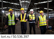 Portrait of team of engineers and technicians that is ready for repairing old machinery to return to normal operation in the company’s old machinery warehouse. Стоковое фото, агентство Ingram Publishing / Фотобанк Лори