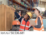 Warehouse foreman and employees Check the imported products in the central warehouse. before delivering to each region’s distribution centers. Стоковое фото, агентство Ingram Publishing / Фотобанк Лори