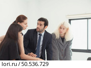In the company meeting room Young executives are brainstorming ideas about a new business that will launch big soon. Стоковое фото, агентство Ingram Publishing / Фотобанк Лори