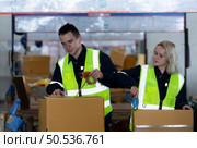 Group of worker in auto parts warehouse Packing small parts in boxes after inspecting the car parts that are ready to be sent to the car assembly plant. Стоковое фото, агентство Ingram Publishing / Фотобанк Лори