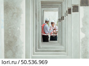 Both of construction engineers verify the constructed precast concrete wall slabs’ quality. also to oversee significant construction projects in the construction zone. Стоковое фото, агентство Ingram Publishing / Фотобанк Лори