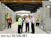 Architects a visit to the construction site. Ready to talk the progress of construction projects in the construction area with construction supervision engineers. Стоковое фото, агентство Ingram Publishing / Фотобанк Лори
