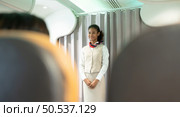 Flight attendants show how to use safety devices and recommend emergency exits. Стоковое фото, агентство Ingram Publishing / Фотобанк Лори