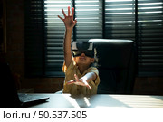 Portrait of little girl in office room of house with gestures that are expressed when playing virtual reality games. Стоковое фото, агентство Ingram Publishing / Фотобанк Лори