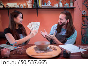 Two young entrepreneurs who own a pottery business. generate enough income from the business to expand the business to accommodate the increasing number of customers. Стоковое фото, агентство Ingram Publishing / Фотобанк Лори
