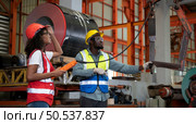 Two technicians Inspecting and testing the operation of lifting cranes in heavy industrial plants. Стоковое фото, агентство Ingram Publishing / Фотобанк Лори