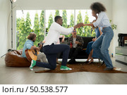 A group of multiethnic friends having fun at a party and witness their friend’s marriage proposal. Стоковое фото, агентство Ingram Publishing / Фотобанк Лори