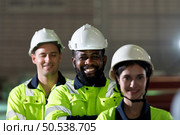 Portrait of a heavy equipment group of engineer from a huge industry who came to inspect the metal sheet factory’s machinery. Стоковое фото, агентство Ingram Publishing / Фотобанк Лори