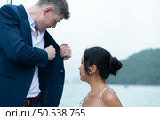 On a yacht, a businessman begins his family’s vacation. a huge project agreement was successfully closed, which was wonderful news. Стоковое фото, агентство Ingram Publishing / Фотобанк Лори
