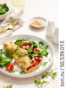 Omelette stuffed with tomato, broccoli feta cheese and fresh green salad. Healthy diet food for breakfast. Стоковое фото, агентство Ingram Publishing / Фотобанк Лори