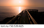 Sunset view from the wooden walkway on Carrapateira, District Aljezur, Algarve Portugal. Стоковое фото, агентство Ingram Publishing / Фотобанк Лори