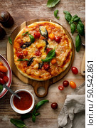 Pizza Margherita on a wooden background. Стоковое фото, агентство Ingram Publishing / Фотобанк Лори